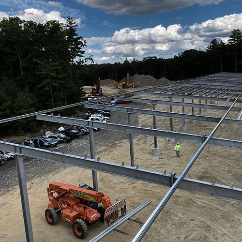 Large ground-mount solar installation with heavy equipment and excavator